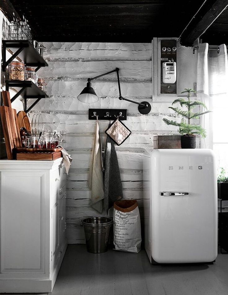 Cozy cabin kitchen with wood wallpaper and miniature Smeg refrigerator