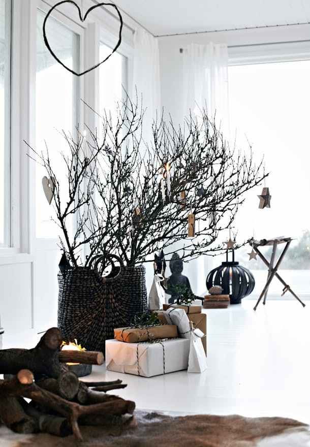 black urn with winter branches in a bright white room