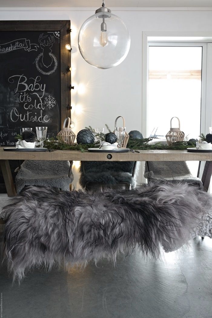 Rustic dining table with modern globe chandelier and chalkboard