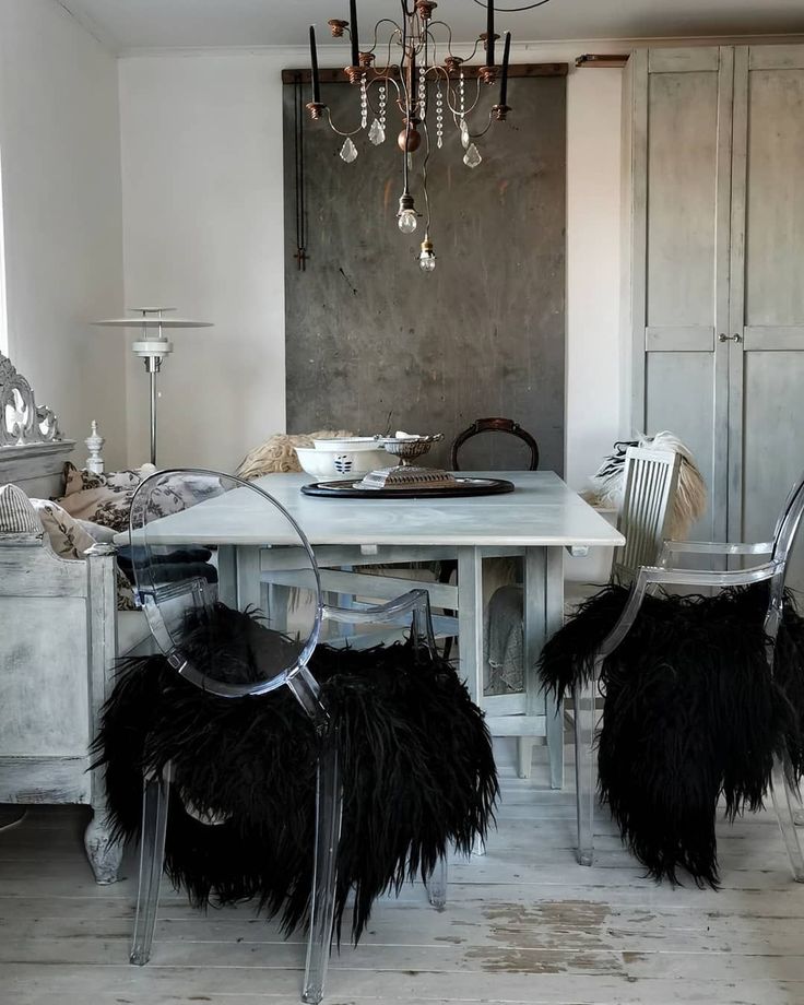 Simple rustic holiday tablescape with acrylic ghost chairs and crystal chandelier