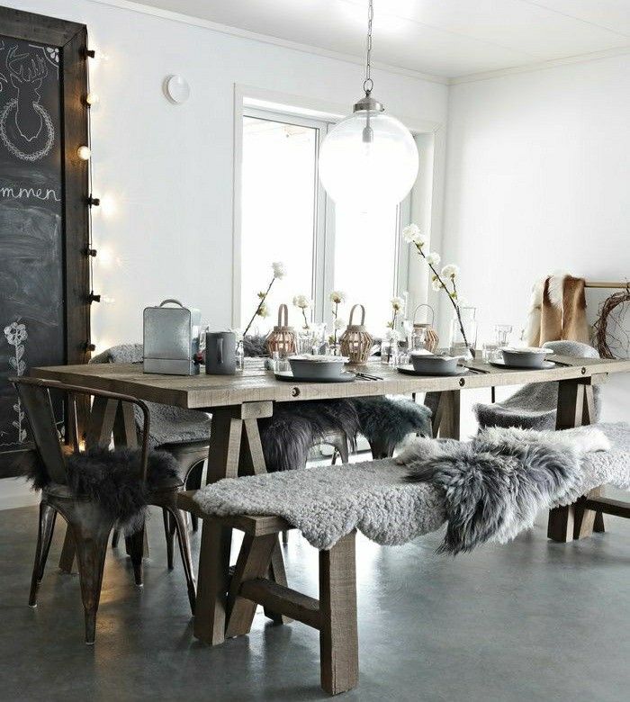 Rustic wooden farmhouse table with chalkboard and sheepskin and flokati throws