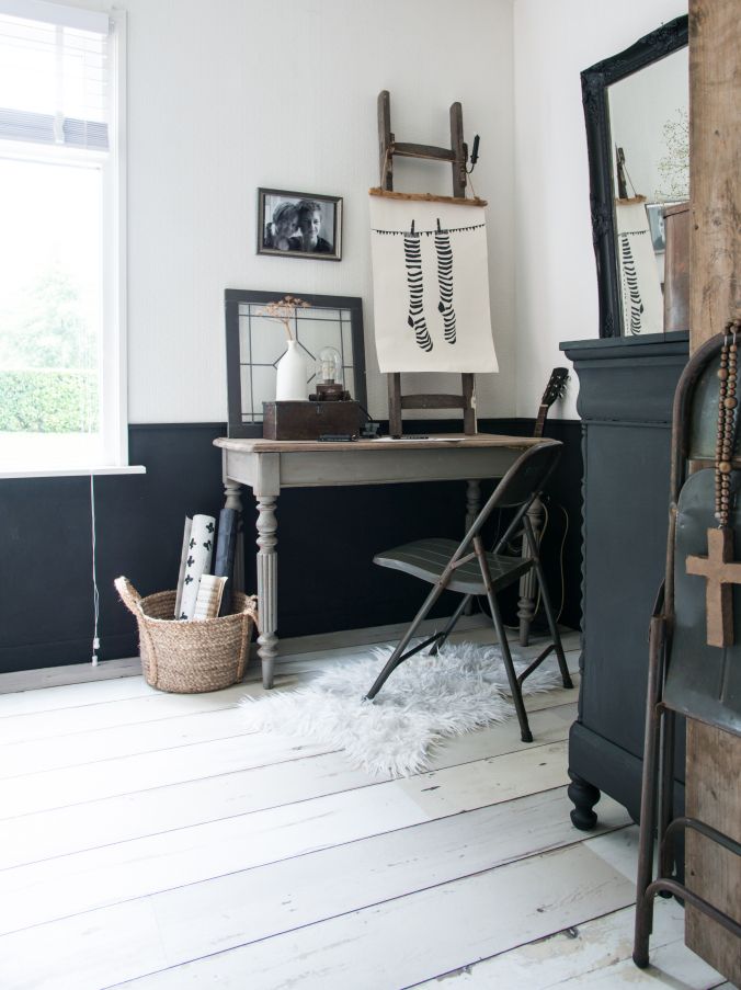 Light-filled artist's studio with white wooden floors and flokati rug