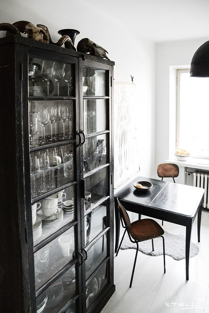 Large black curio cabinet stocked with glassware