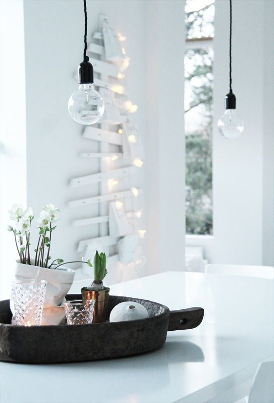 White wooden Christmas tree wall art with clear lightbulbs