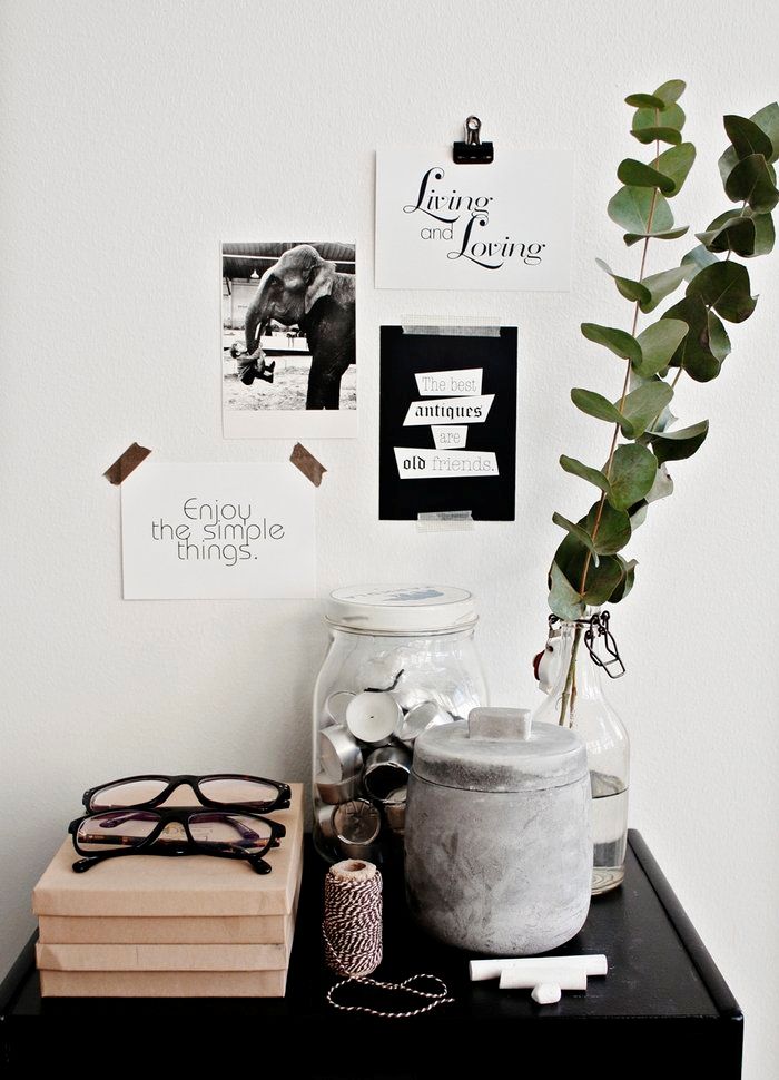 Eucalyptus branch in a vase with black and white photos and washi tape