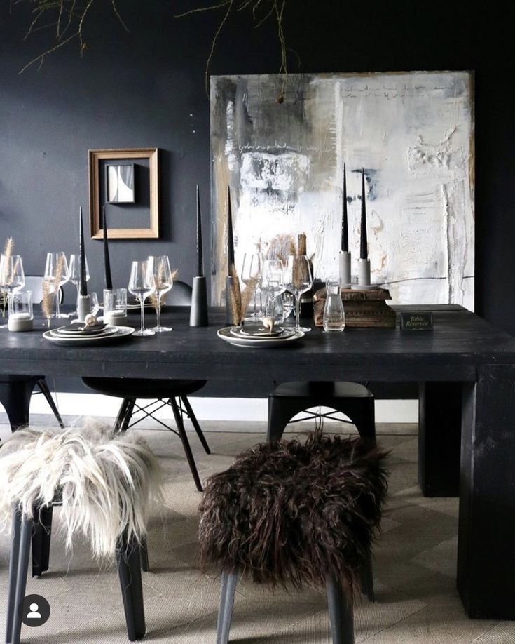 Dark moody tablescape with sheepskin throws and oversized antique mirror
