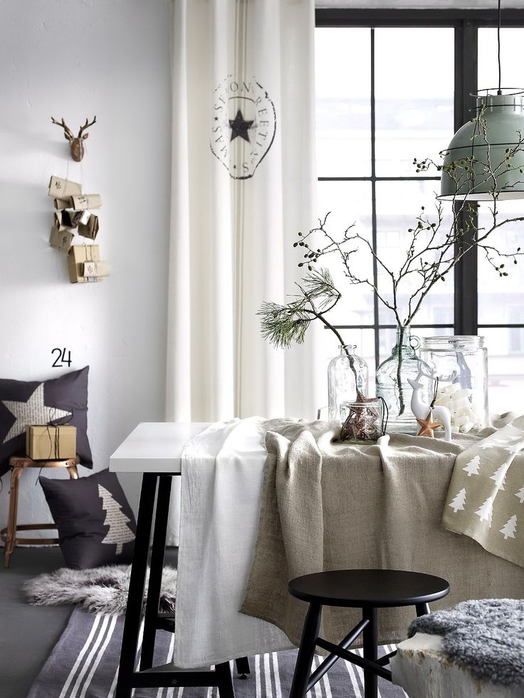 Holiday dining table with pine branches and shabby chic stamped white canvas curtains