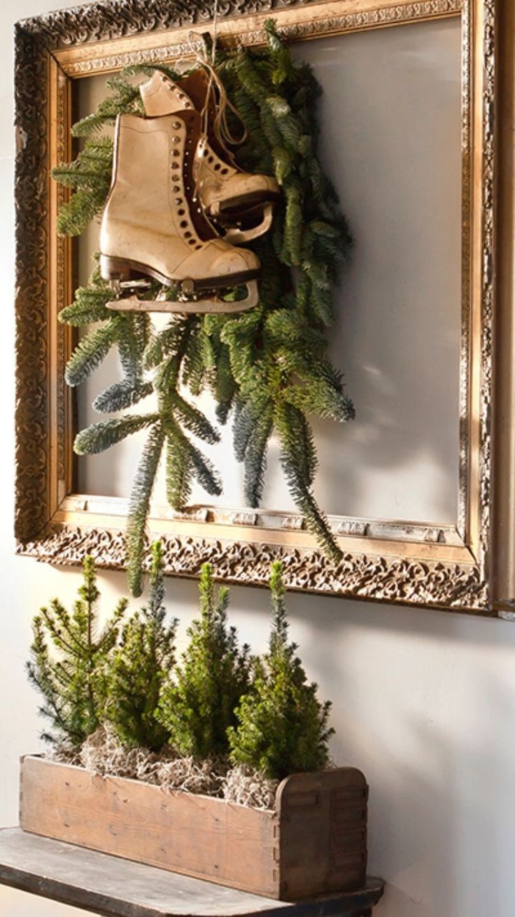 Empty ornate gold frame with pine boughs and vintage ice skates