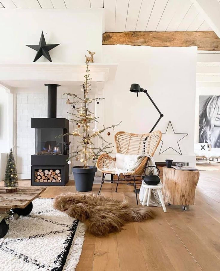 Beautiful Scandinavian loft with wood stove, tan sheepskin rug, wicker chair and exposed beams