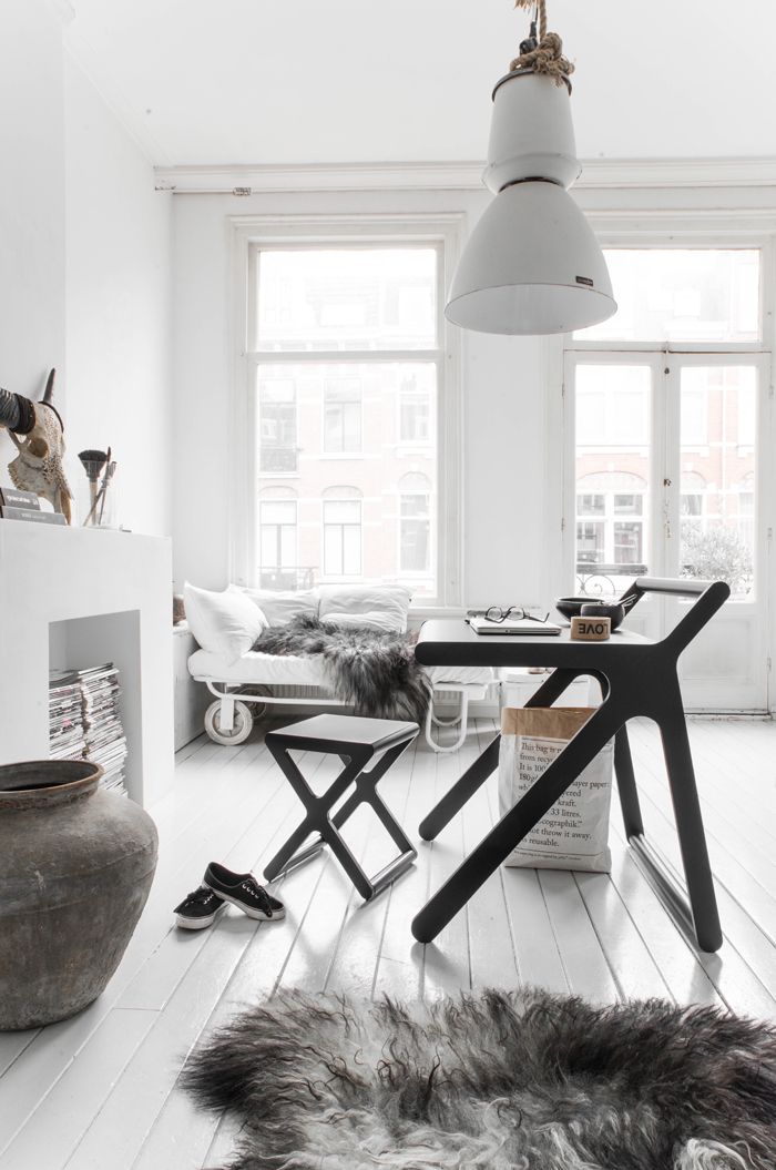 Beautiful light filled Scandinavian loft with white wood floors and flokati rug