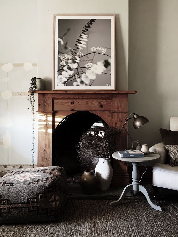 Wooden fireplace with black and white botanical print over it