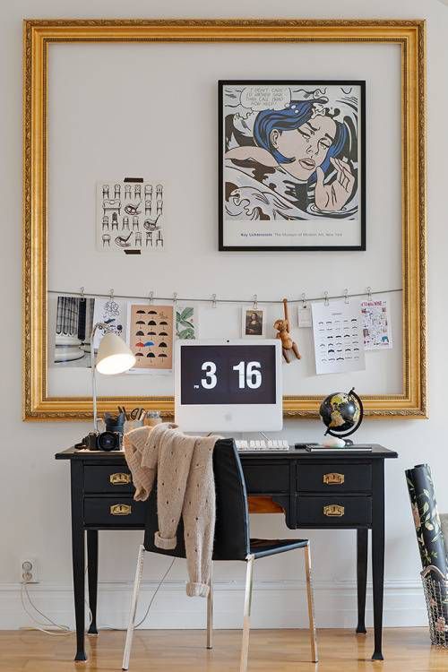 A vibrant and eclectic workspace with a white desk filled with colorful stationery and decor items. The wall is adorned with a bulletin board filled with photos, notes, and memorabilia, creating a creative and personalized inspiration corner.