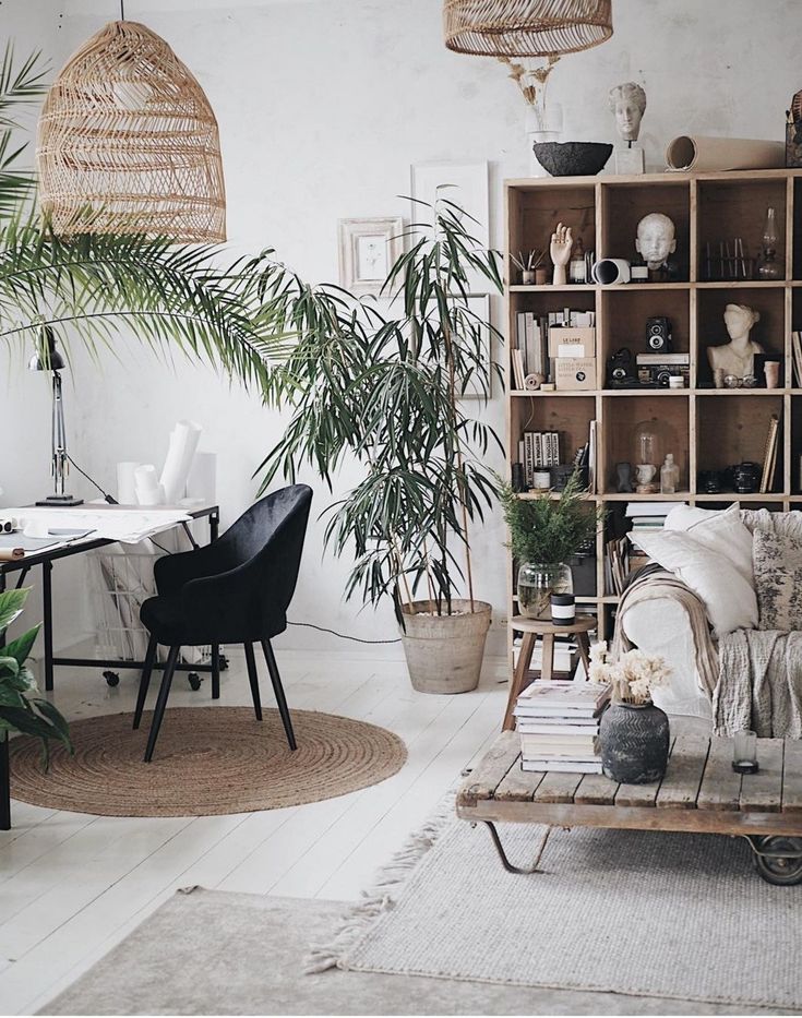 Bright whitewashed interior with a hanging fern, rustic wood stool, and vintage mirror, styled with soft greenery and clean Scandinavian charm.