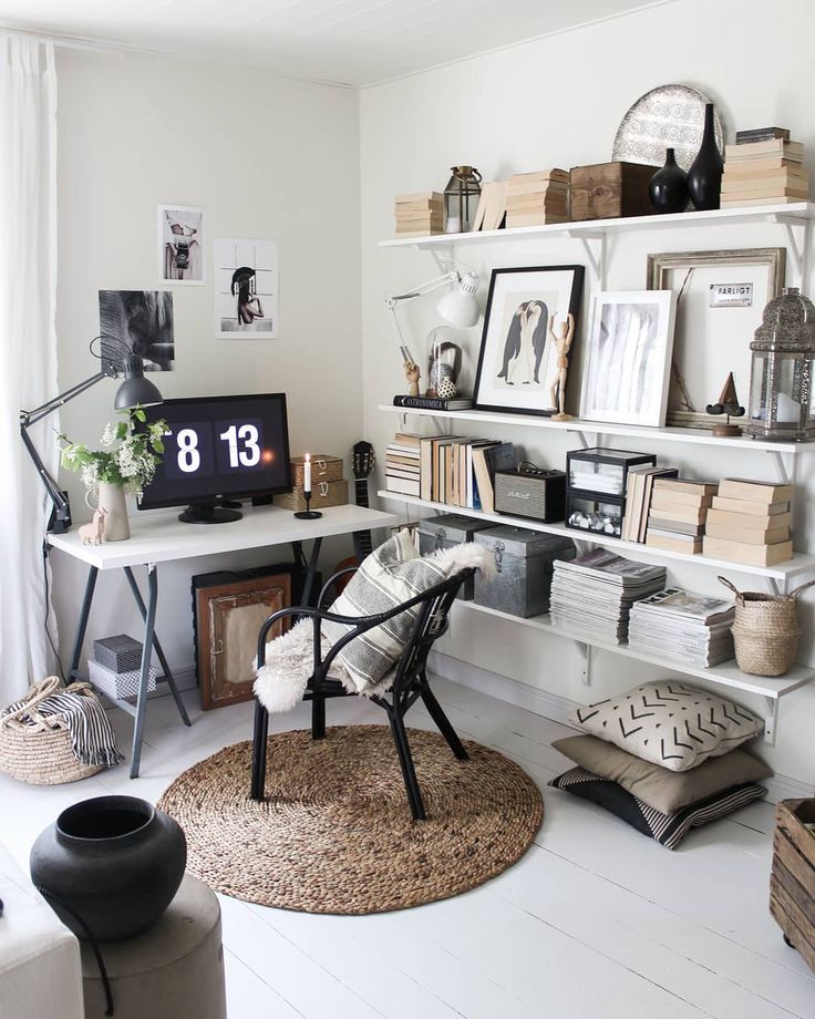 Stylish entryway wall with black metal coat hooks and layered winter coats, blending function and seasonal decor.