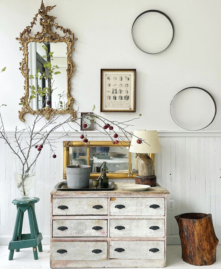 An image highlighting the use of framed nostalgic art with a scientific theme. Simple black-and-white framed patent prints are displayed on a bedroom nightstand, adding historical interest to the decor.