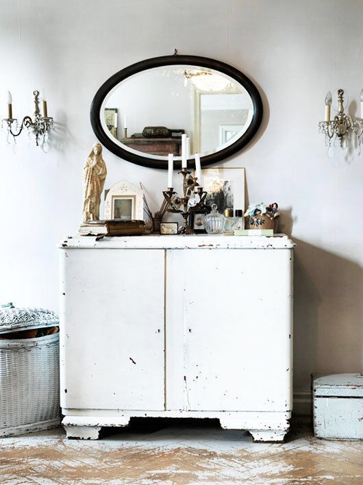 A large, chest-style cabinet with many small wooden drawers and antique brass pulls, suggesting rich, organized storage.