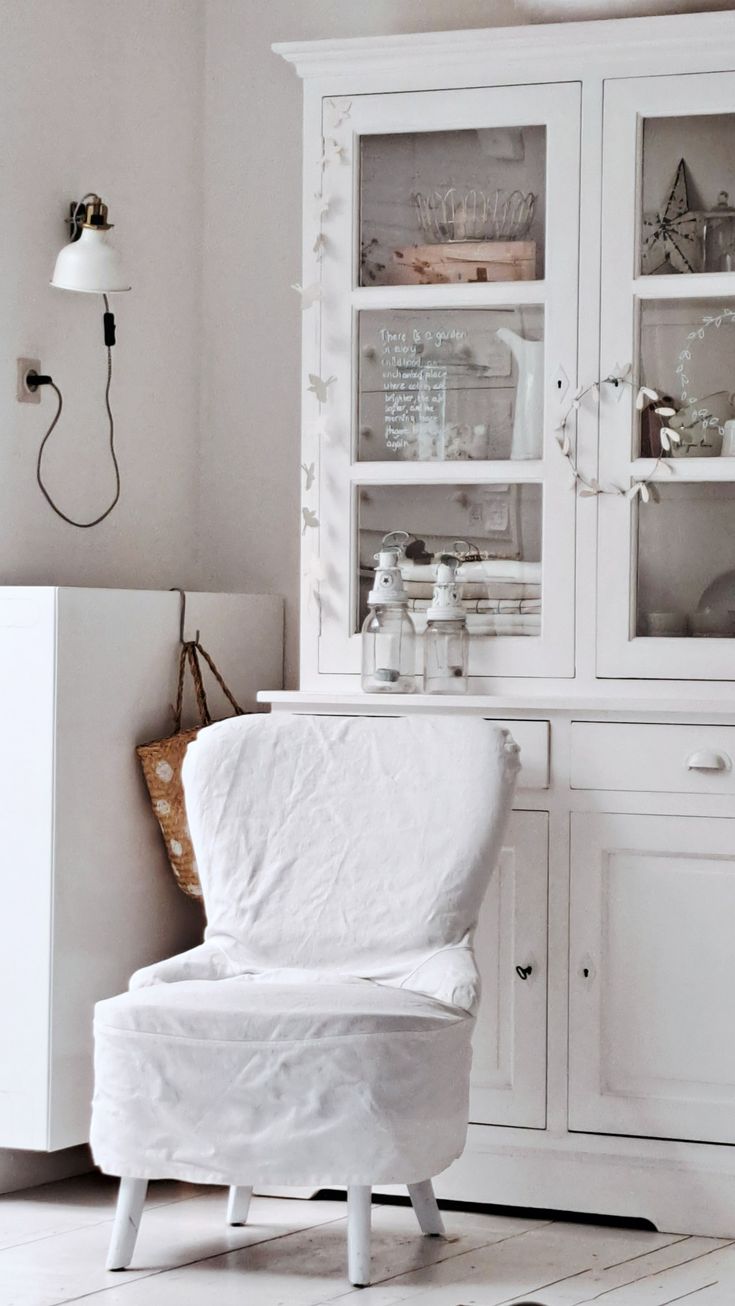 A clean-lined contemporary sofa featuring a crisp, snugly-fitted white canvas slipcover, styled with neutral pillows and set against a minimalist interior backdrop.