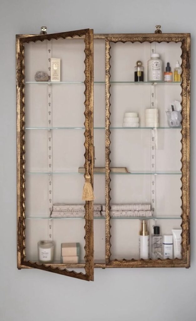 A vintage Louis XV-style wooden chest converted into a bathroom vanity, featuring an undermount sink, a thick honed marble countertop, and elegant curved legs.