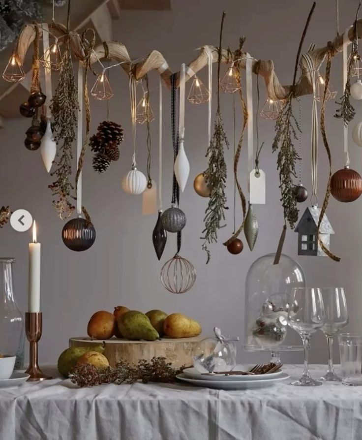 A cluster of delicate warm white fairy lights glowing inside a glass cloche, placed on a cozy mantel decorated with white candles and pinecones.