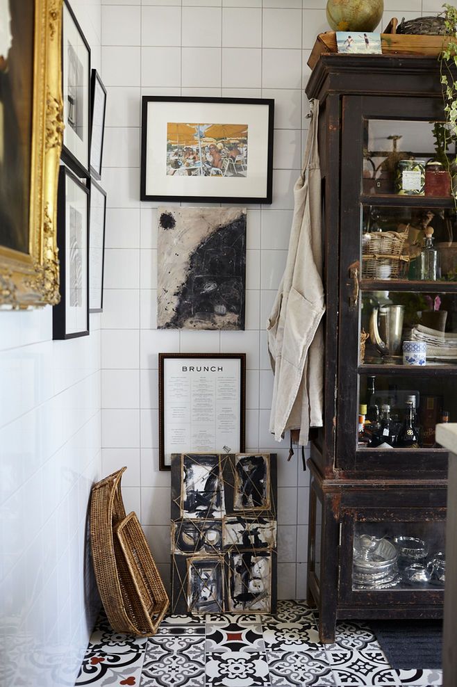 An image highlighting the "structured nature" of Euro Chic decor; the greenery feels architectural and intentional, while the shelf styling emphasizes quality and breathing room over storage.