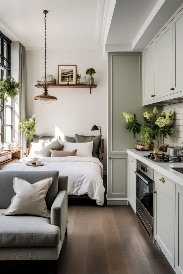 A collection of trailing Pothos and String of Hearts plants hanging from the high ceiling at staggered heights. The vines create a living 'green curtain' in front of a tall window, filtering the sunlight into the open-plan living space.