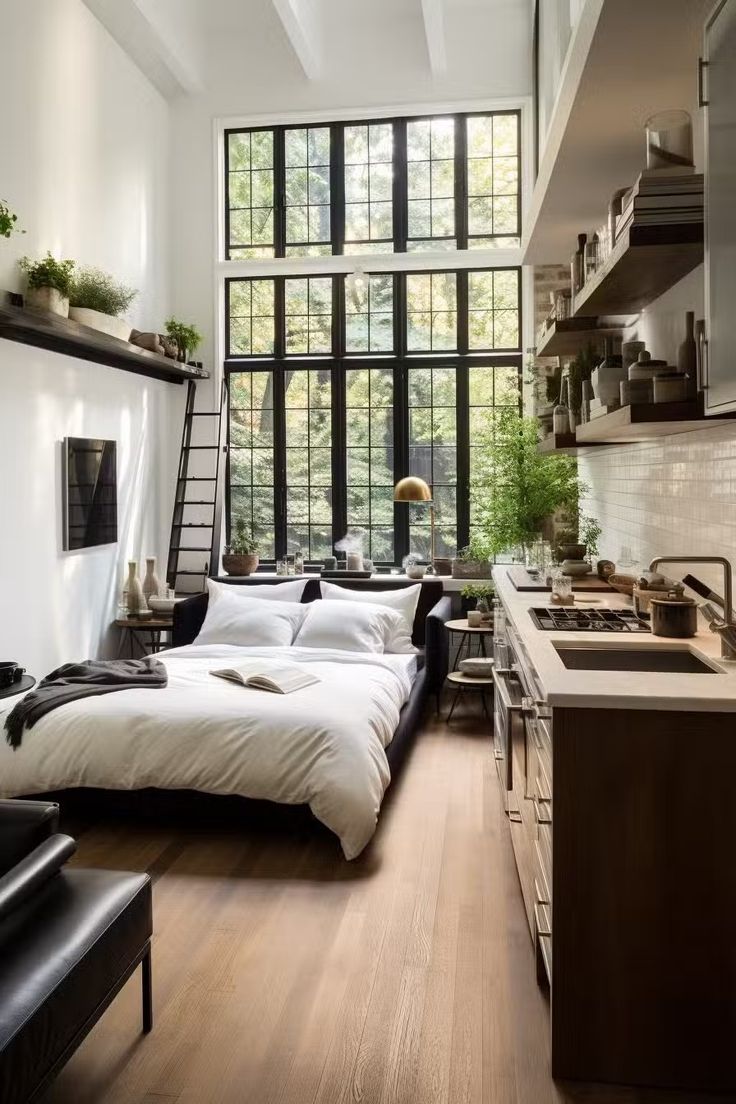 A large Bird of Paradise plant in a textured charcoal planter, standing six feet tall to match the height of industrial loft windows. The lush green leaves provide a soft, organic contrast to the exposed brick wall behind it